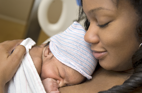 A mother holds her infant child.